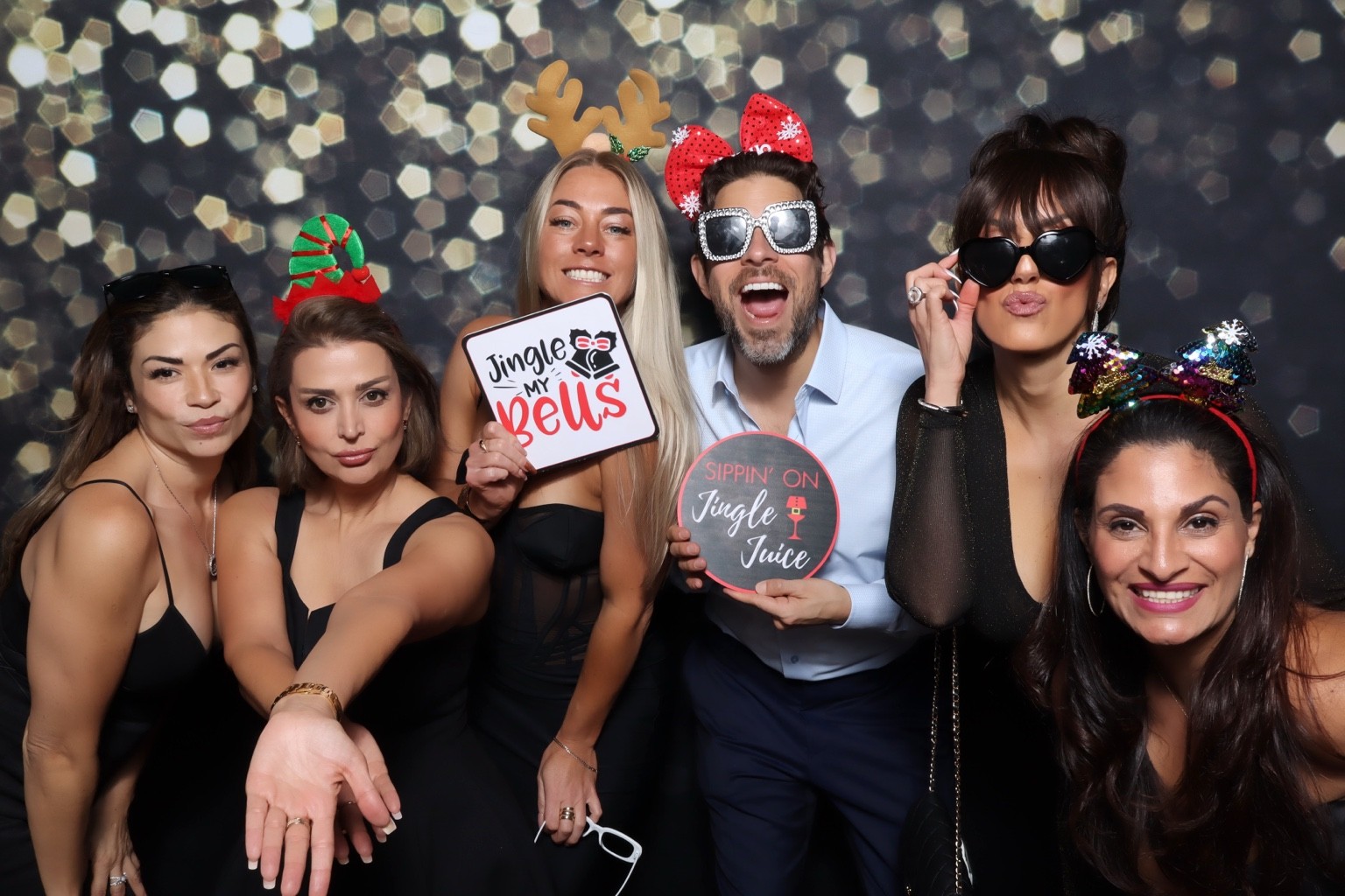 Guests posing with holiday props