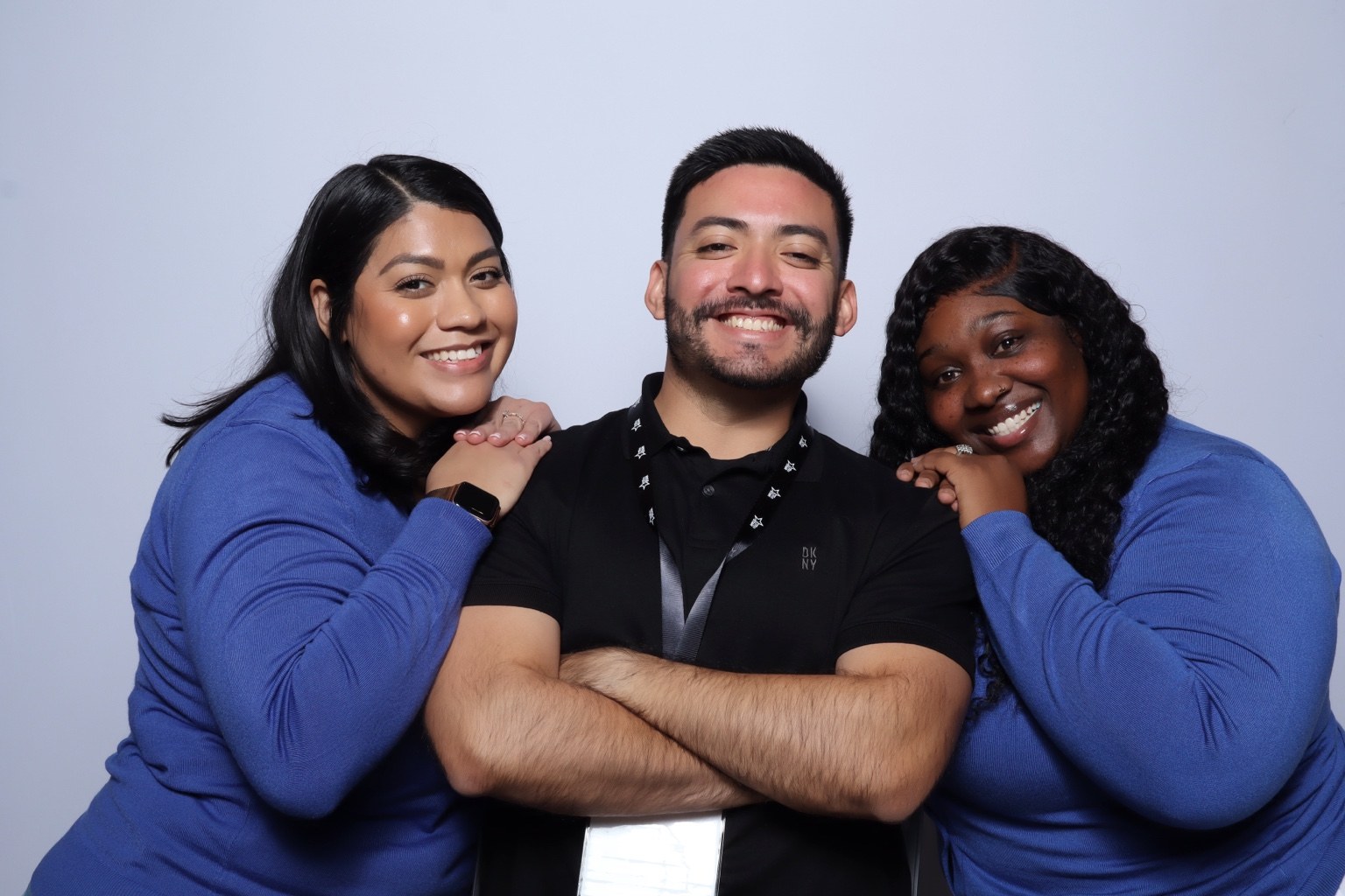 Three guests smiling at a corporate event