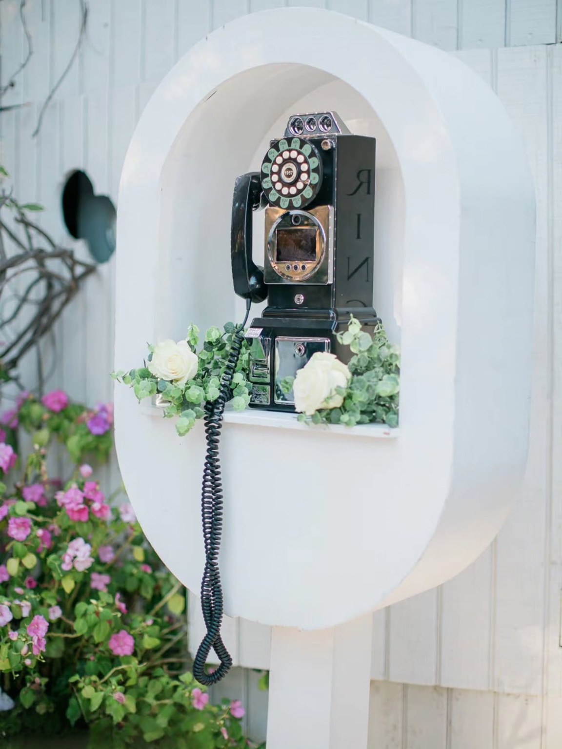 Tinseltown audio and video guestbook in its white floral arch