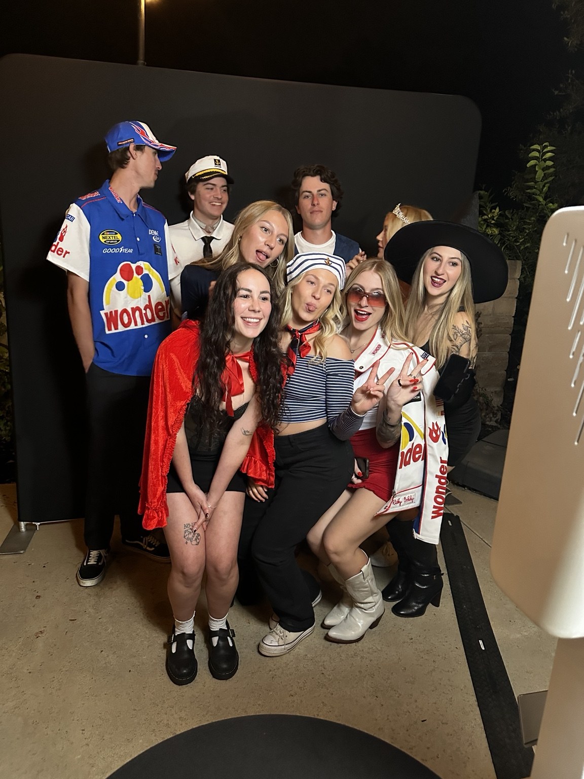 Costumed guests gathered around the booth