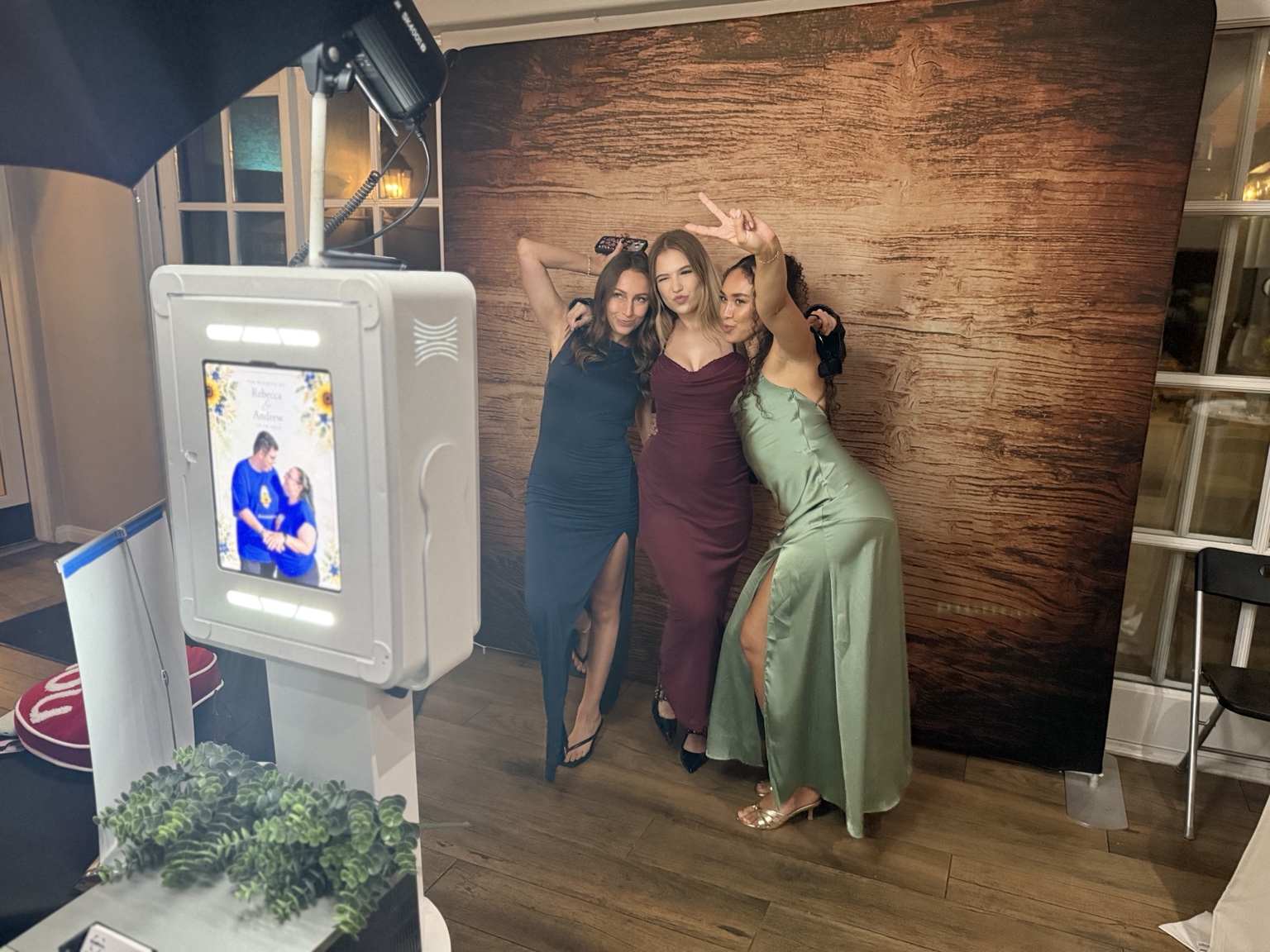 Three wedding guests posing together at the Lux Booth