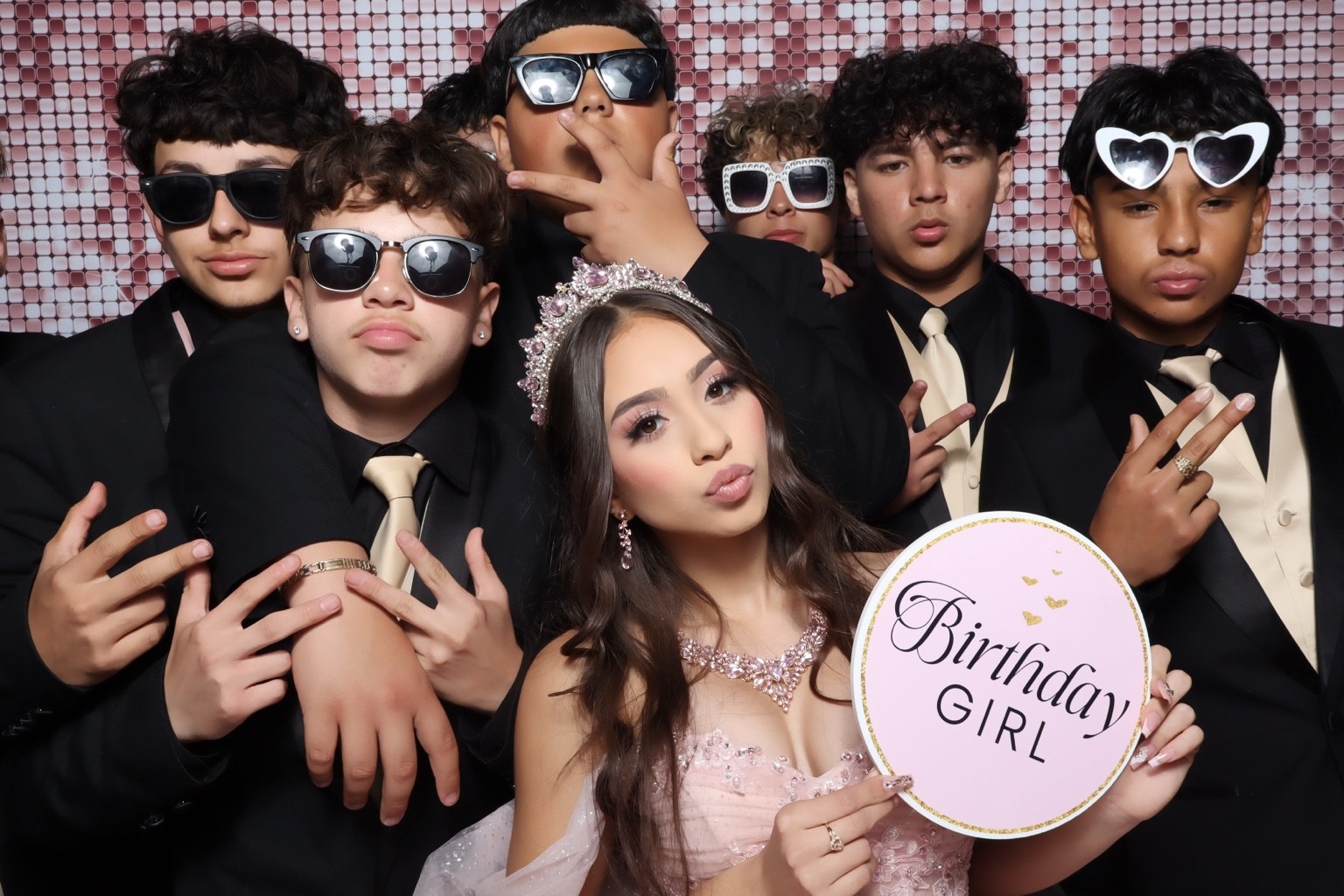 Birthday girl and friends posing with sunglasses and photo booth props