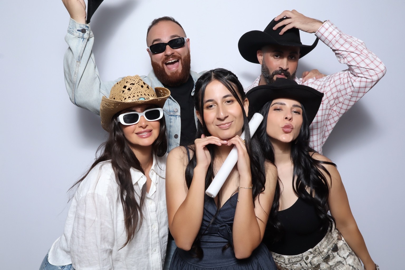 Sweet 16 guests enjoying photo booth hats and sunglasses