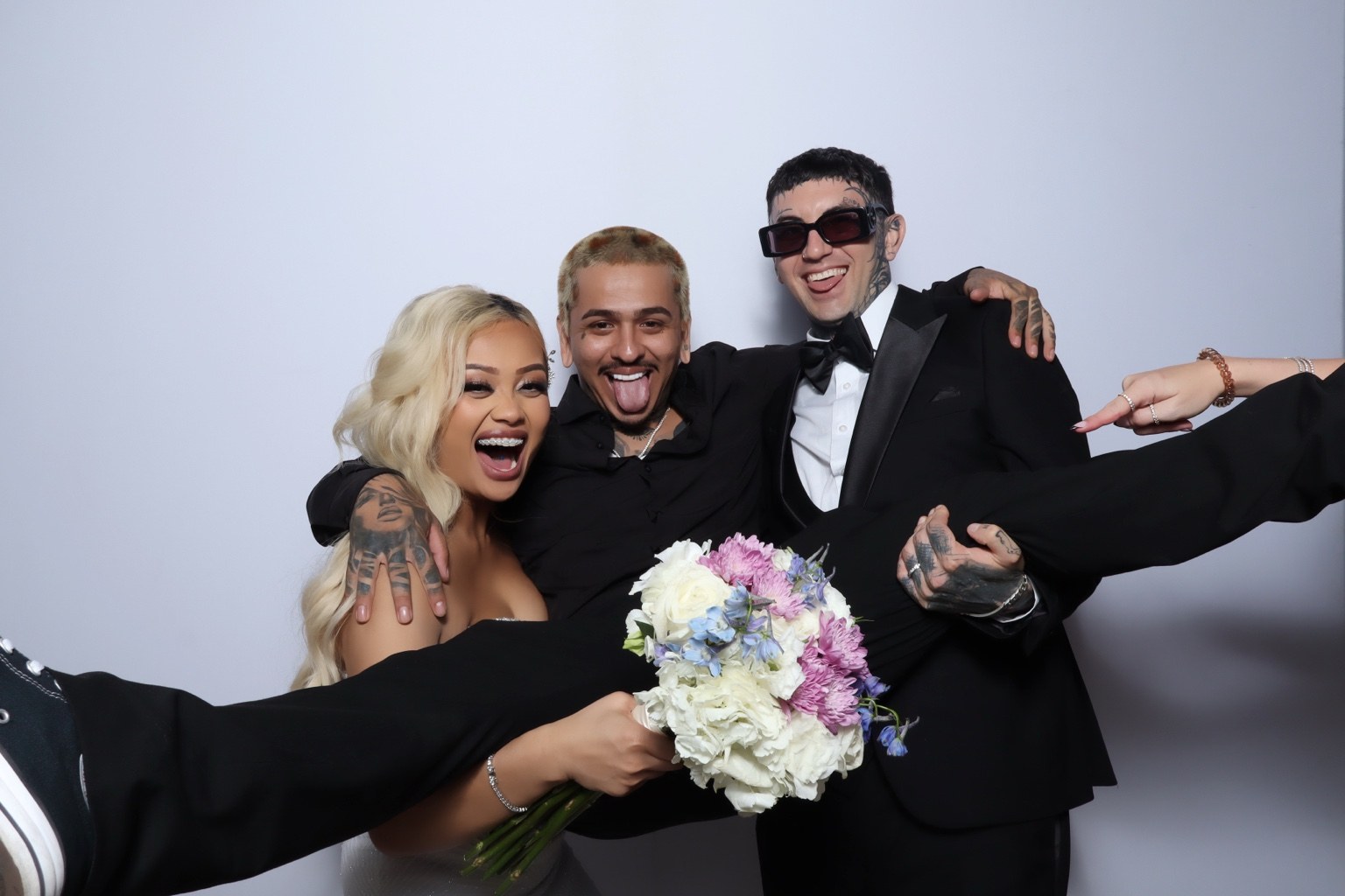 Wedding couple celebrating with a guest